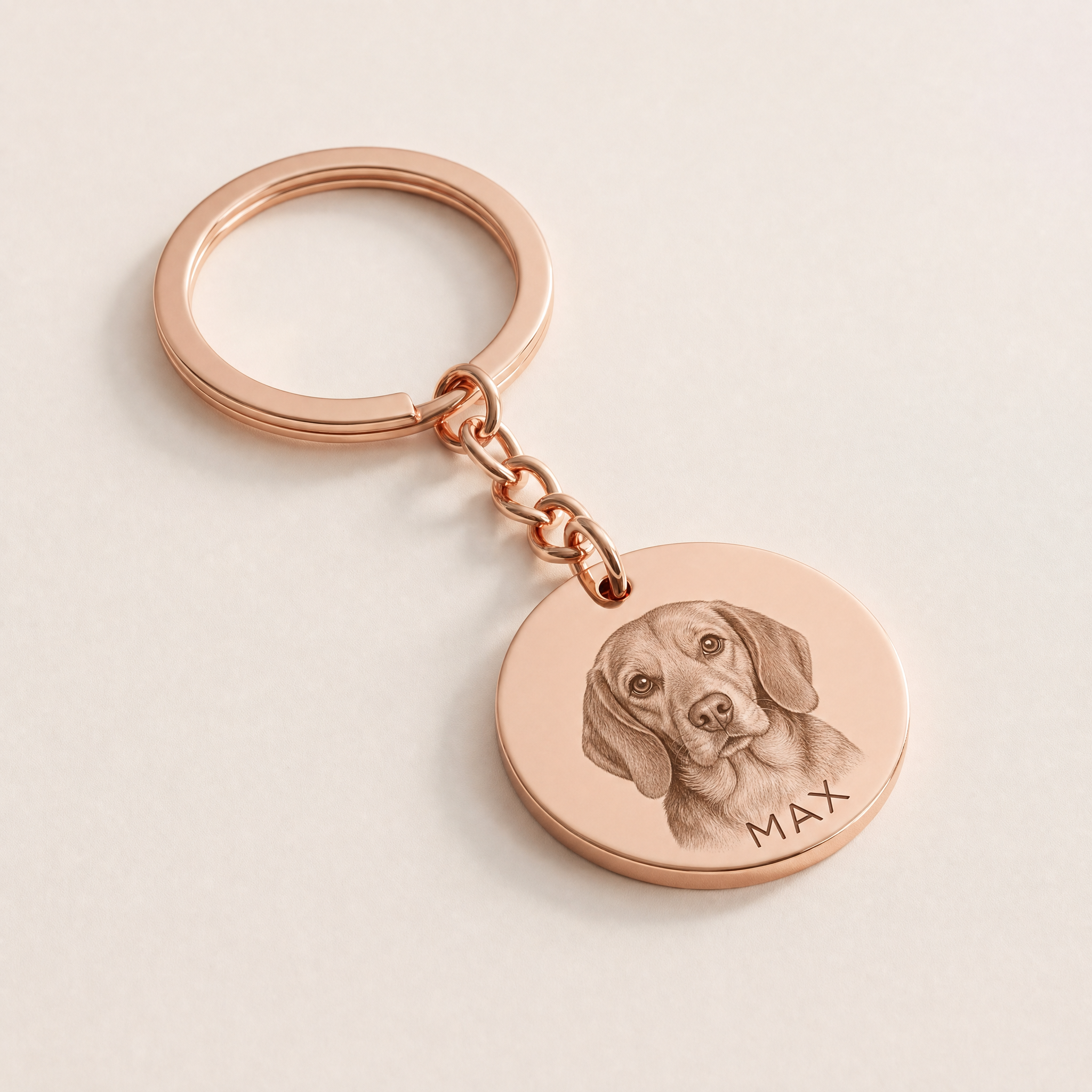 Pet portrait keyring in rose gold, a dog's photo engraved into the steel disc with his name curved beneath
